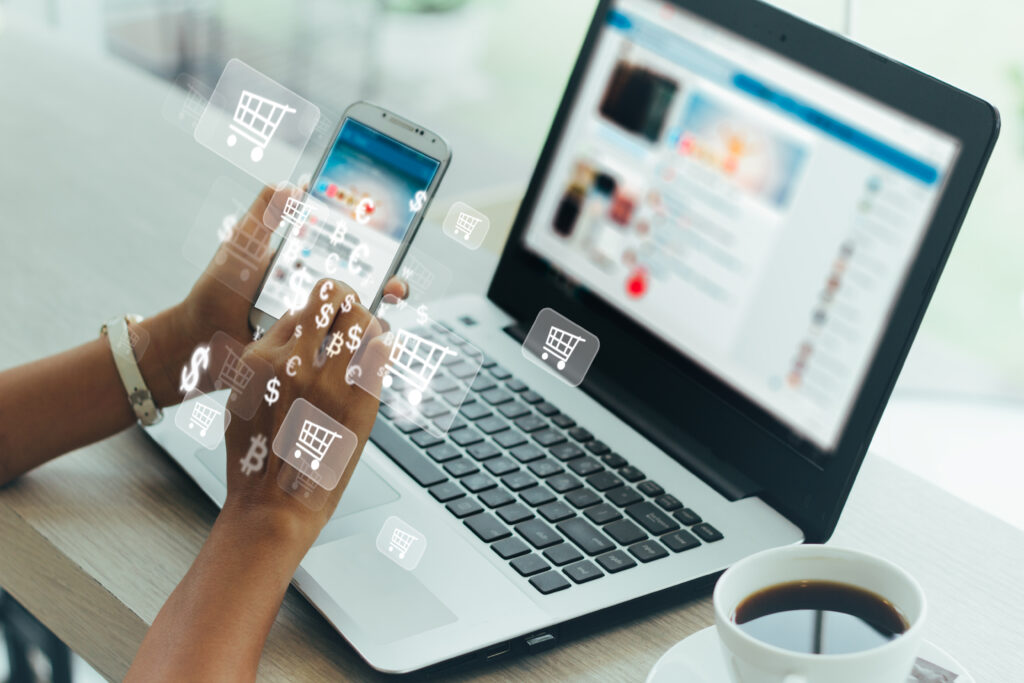 Businesswoman using phone and laptop